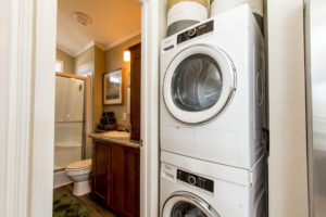 Image of upgrade to have stackable washer-dryer installed. Image also shows standard venitaltion fan for bathroom.