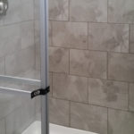 Home comes standard with 1-piece 48" white fiberglass walk in shower. Pictured above is upgrade to 48" tile shower