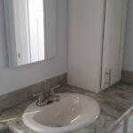Image of standard bathroom sink. Image shows upgraded HD laminate countertops.