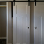 Upgraded bedroom closets to include sliding white craftsman doors. White bi-fold closet doors are standard.